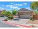 Well-kept single-story home featuring a two-car garage, xeriscaping, and manicured bushes at 329 Gemstone Hill Ave, North Las Vegas, NV 89031