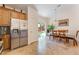 Bright kitchen with stainless steel refrigerator and a dining area with backyard access at 329 Gemstone Hill Ave, North Las Vegas, NV 89031