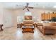 Inviting living room with vaulted ceiling, tile flooring, ceiling fan, and comfortable seating at 329 Gemstone Hill Ave, North Las Vegas, NV 89031