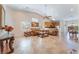 Open concept living room featuring tile floors, furniture, and a dining area at 329 Gemstone Hill Ave, North Las Vegas, NV 89031
