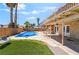 Outdoor oasis showcasing a sparkling pool, covered patio area, and comfortable seating at 4356 Sabadell St, Las Vegas, NV 89121