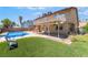Beautiful backyard with a refreshing pool, covered patio, and well-maintained artificial turf at 4356 Sabadell St, Las Vegas, NV 89121