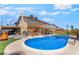 Spacious backyard showcasing a pool, covered BBQ area, and a lush artificial grass lawn at 4356 Sabadell St, Las Vegas, NV 89121