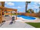 Inviting backyard space featuring a pool, covered patio, and outdoor cooking area at 4356 Sabadell St, Las Vegas, NV 89121