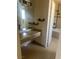 This bathroom features a light stone vanity with a large mirror and a shower over tub with tile surround at 4356 Sabadell St, Las Vegas, NV 89121