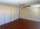 This bedroom includes hardwood floors, a ceiling fan, and a large closet with sliding doors at 4356 Sabadell St, Las Vegas, NV 89121