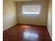 Bedroom with hardwood floors, a ceiling fan and a window bringing in natural light at 4356 Sabadell St, Las Vegas, NV 89121
