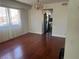 Dining room featuring wood floors, neutral walls, a chandelier, and view into kitchen at 4356 Sabadell St, Las Vegas, NV 89121
