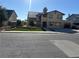 Two-story home featuring solar panels, a two-car garage, green front yard, and a tan exterior at 4356 Sabadell St, Las Vegas, NV 89121