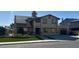 Two-story home featuring solar panels, a two-car garage, green front yard, and a tan exterior at 4356 Sabadell St, Las Vegas, NV 89121