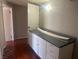Hallway with white cabinets and trim against dark wood flooring and gray walls at 4356 Sabadell St, Las Vegas, NV 89121