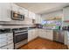 Kitchen with white cabinetry, granite counters, and stainless-steel appliances at 4356 Sabadell St, Las Vegas, NV 89121