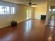 Large living room featuring a fireplace, french doors, wood-look floors, and ceiling fan at 4356 Sabadell St, Las Vegas, NV 89121