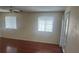 Living Room with hardwood floors, two windows and glass paned door with blinds at 4356 Sabadell St, Las Vegas, NV 89121