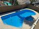 A sparkling blue backyard pool features an attached spa in a desert landscape at 4356 Sabadell St, Las Vegas, NV 89121