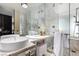 Modern bathroom with double sinks, marble tile, glass shower, and luxurious amenities at 4381 W Flamingo Rd # 18320, Las Vegas, NV 89103