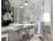 Modern bathroom with double sinks, marble tile, glass shower, and luxurious amenities at 4381 W Flamingo Rd # 18320, Las Vegas, NV 89103
