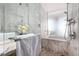 Sleek bathroom featuring marble tile, a glass-enclosed shower, and modern chrome fixtures at 4381 W Flamingo Rd # 18320, Las Vegas, NV 89103