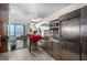 Condo kitchen with stainless steel appliances and breakfast bar, open to the living area at 4381 W Flamingo Rd # 18320, Las Vegas, NV 89103