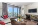 Well-lit living room with cozy seating, cityscape view, and sleek decor at 4381 W Flamingo Rd # 18320, Las Vegas, NV 89103