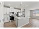 Modern kitchen with white cabinets, stainless steel appliances, and a center island with marble countertop at 4417 Pioche Ave, North Las Vegas, NV 89032