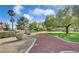 Expansive backyard with mature trees, lush lawn, and a winding pathway through landscaped areas at 4649 Bird View Ct, Las Vegas, NV 89129