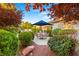 Landscaped backyard patio area with dining table and shade umbrella, perfect for outdoor relaxation at 4649 Bird View Ct, Las Vegas, NV 89129