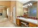Elegant bathroom vanity with tile countertop, large mirror, and decorative glass block window at 4649 Bird View Ct, Las Vegas, NV 89129