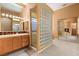 Elegant bathroom featuring glass block shower, custom lighting, and and sinks at 4649 Bird View Ct, Las Vegas, NV 89129