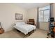 Comfortable bedroom with bright window, musical instruments, and neutral color scheme at 4649 Bird View Ct, Las Vegas, NV 89129