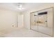 Spacious bedroom with a large mirrored closet, ceiling fan and ample natural light at 4649 Bird View Ct, Las Vegas, NV 89129
