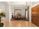 Formal dining room features elegant chandelier, large mirror, and views to living area at 4649 Bird View Ct, Las Vegas, NV 89129