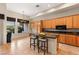 Bright kitchen featuring tile floors, breakfast bar, natural wood cabinets, and lots of counter space at 4649 Bird View Ct, Las Vegas, NV 89129