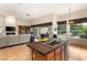 Bright kitchen with breakfast bar, natural wood cabinets, stainless steel dishwasher, and an open floor plan at 4649 Bird View Ct, Las Vegas, NV 89129
