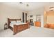 Bright main bedroom featuring a fireplace, large windows with custom curtains and a natural wood bed frame at 4649 Bird View Ct, Las Vegas, NV 89129