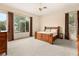 Bright main bedroom featuring large windows with custom curtains and an impressive natural wood bed frame at 4649 Bird View Ct, Las Vegas, NV 89129