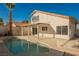 Backyard featuring a refreshing pool, covered patio, and desert landscaping at 4669 Winfield Dr, Las Vegas, NV 89147