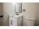 Modern bathroom with a white vanity, marble countertop, and a stylish arched mirror at 4669 Winfield Dr, Las Vegas, NV 89147