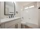 Stylish bathroom featuring a marble countertop vanity, framed mirror, and shower-tub combo at 4669 Winfield Dr, Las Vegas, NV 89147