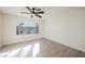 Bright bedroom with a large window offering scenic views and a ceiling fan at 4669 Winfield Dr, Las Vegas, NV 89147