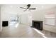 Bright living room with a black brick fireplace, ceiling fan, and sliding glass doors to the backyard at 4669 Winfield Dr, Las Vegas, NV 89147