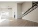Open living room with tall ceilings, a modern ceiling fan, and a staircase with black railings at 4669 Winfield Dr, Las Vegas, NV 89147