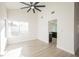 Living room with tall ceilings, a modern ceiling fan, and view into the kitchen at 4669 Winfield Dr, Las Vegas, NV 89147