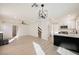 Open-concept living space featuring a modern kitchen with white cabinets and stainless steel appliances at 4669 Winfield Dr, Las Vegas, NV 89147