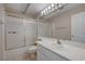 Bathroom with shower-tub combo, tile floors, and vanity with sink and large mirror at 472 Staghorn Pass Ave, Las Vegas, NV 89183