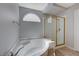 Bathroom showcasing a bathtub with tile surround and a glass-enclosed shower with gold trim at 472 Staghorn Pass Ave, Las Vegas, NV 89183
