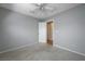 Neutral bedroom with a ceiling fan, a white door, and neutral carpet at 472 Staghorn Pass Ave, Las Vegas, NV 89183
