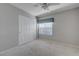 Neutral bedroom with a ceiling fan, a window, and a closet with folding doors at 472 Staghorn Pass Ave, Las Vegas, NV 89183