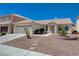 Single story home with a two car garage, low maintenance yard and desert landscaping at 472 Staghorn Pass Ave, Las Vegas, NV 89183