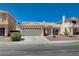 Single story home with a two car garage, low maintenance yard and desert landscaping at 472 Staghorn Pass Ave, Las Vegas, NV 89183